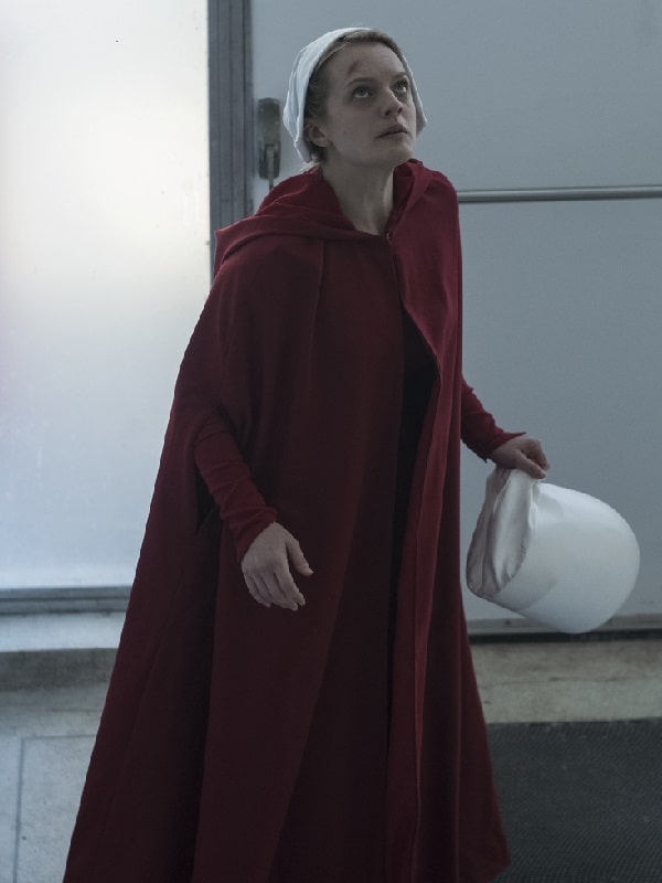 Actress Elisabeth Moss Wearing Maroon Cape In The Handmaid's Tale as June Osborne