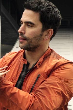 Ignacio Serricchio Wearing Orange Jacket In Lost in Space Series
